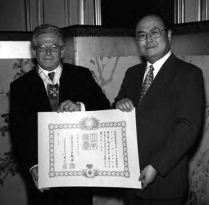 photo of two men holding a certificate