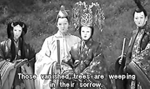 several figures in robes wearing masks.