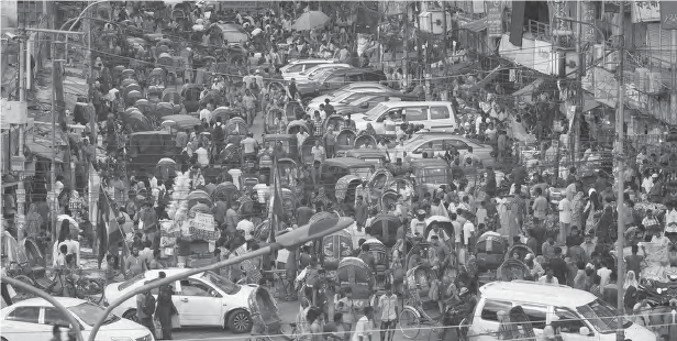 photo of a large group of people in between many cars