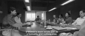 photo of people sitting at a conference table, with the caption "a women's team exists just as a formality and nothing else"