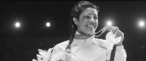 photo of a woman smiling with a medal