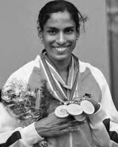 photo of a young woman with three medals