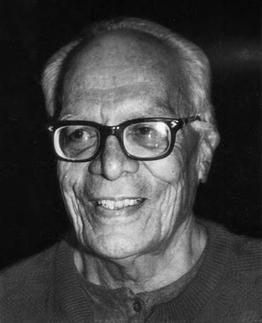 Akhtar Hameed Khan as an old man wearing thick black glasses. 