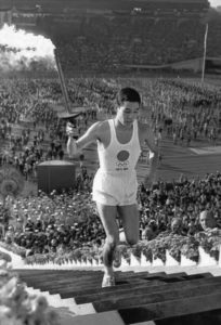 photo of a man running with a torch