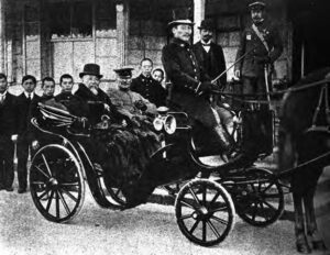 photo of several men in suits on a horse-drawn carriage