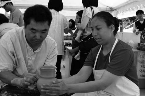 Visitors learning to cast ceramic vessels.