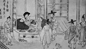 several robed figures are gathered around a table of food that is outside