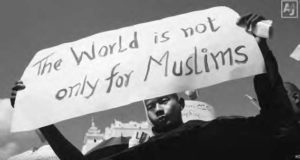 a protest sign reading "the world is not only for muslims"
