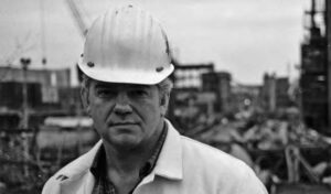 photo of a man in a suit and a safety helmet