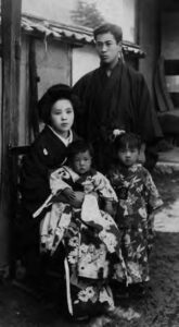 photo of a man and woman with two young girls in kimono