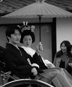 photo of a man and woman holding an umbrella