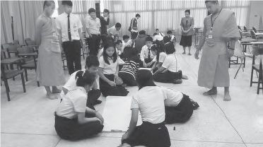 photo of people working on a banner on the floor 