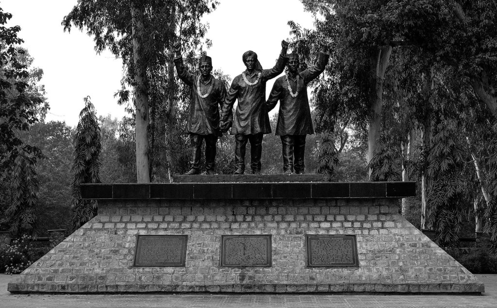 The National Martyrs Memorial in the Indian town of Hussainiwala on the Pakistani border with the Indian state of Punjab is a memorial for Bhagat Singh, Sukhdev, and Rajguru, who were cremated here in 1931 after their execution at the Lahore Jail. The statues are of three men doing a clothes fist salute. 