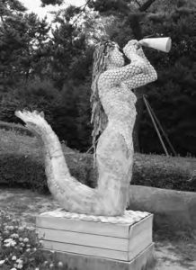 statue of a mermaid blowing a horn