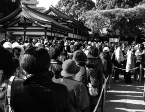 a photo of a large gathering of people outside of a temple