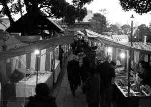 photo of people walking through stalls on either side