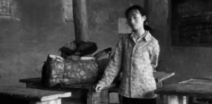 a young girl stands by her luggage