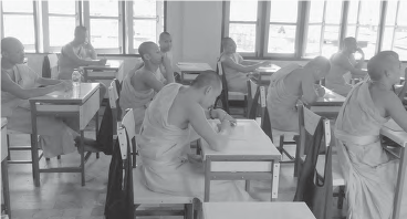 photo of monks sitting at desks