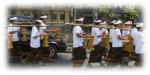 A group of Balinese dancers march in a line. 