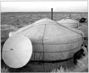photo of a satellite dish next to a yurt