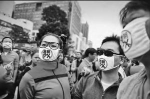 Photo of protesters wearing facemasks on the street
