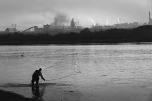 Image of a fisherman casts his net in the  River 