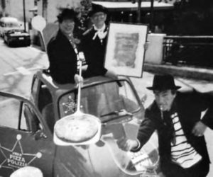 photo of men in a car holding a pizza box