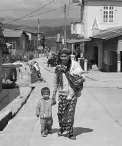 photo of a man and his child walking up a street