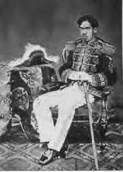 a man in regal military uniform sitting on a chair with a sword