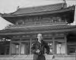 a woman standing in front of a shrine