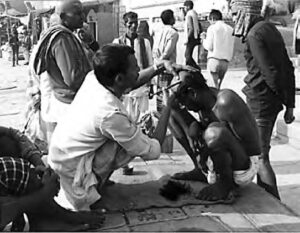 photo of a man cutting another man's hair