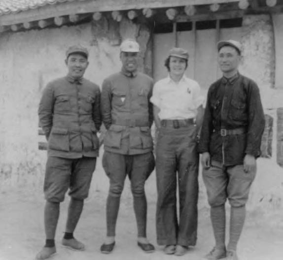 photo of a woman posing with three military officers