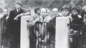 Photograph of Jewish men crowding around the gate to Sugihara's consulate. 
