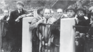 Photograph of Jewish men crowding around the gate to Sugihara's consulate.