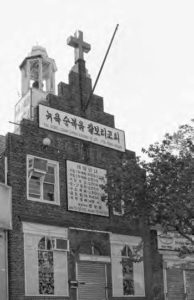 photo of the outside of a church. there is a banner with hangul on it.