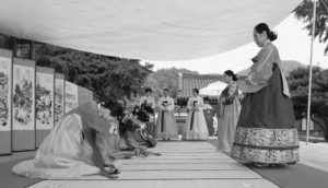 several women bow to other women in hanbok.