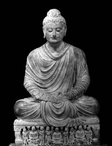 a statue of the buddha sitting cross legged, with his hands in his lap