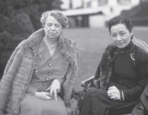 Soong Mei-Ling with First Lady Eleanor Roosevelt. Soong is wearing a traditional cheongsam and Roosevelt is wearing a dress with a fur coat. 