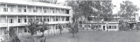 A large building in front of a courtyard. 