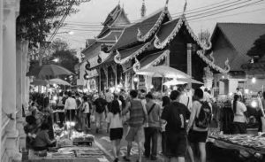 Chiangmai Sunday market walking street in the city center. The market is crowded with people. 
