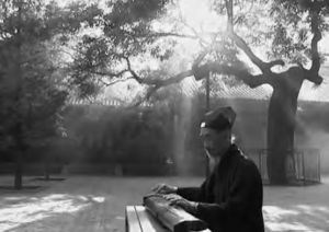 photo of an old man playing the qin