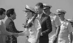 photo of men in military uniforms and suits shaking hands