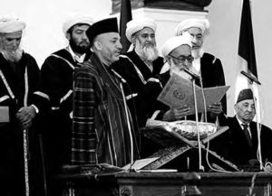 photo of a group of men speaking in front of a podium