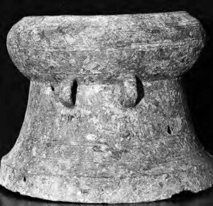 photograph of a rusted drum, that is rounded at the top