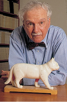 Photo of Professor Nathan Sivin, standing behind a sculpture of a cat mid-stride.