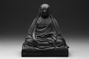 photo of a sitting monk statue 
