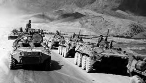 photo of a line of tanks driving away