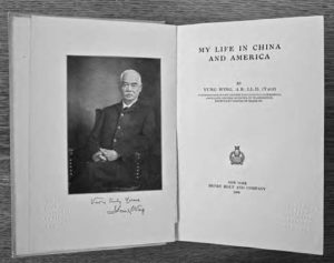 photo of an open book, showing a portrait of the author and the title page