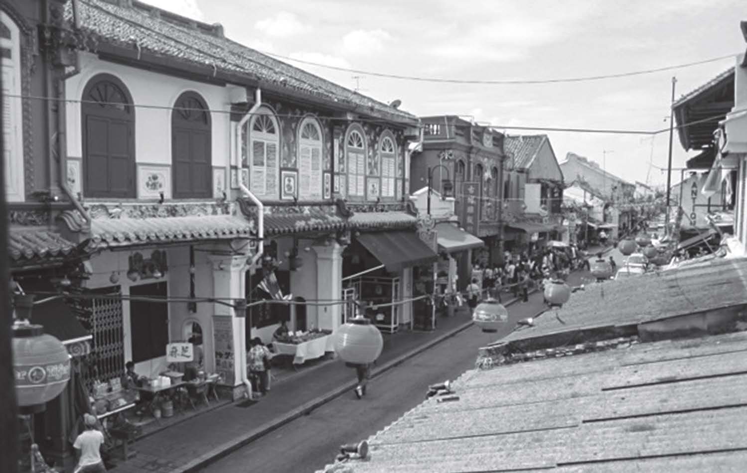 photo of a street lined with shops and people