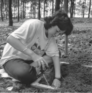 A female student is excavating the dirt. 